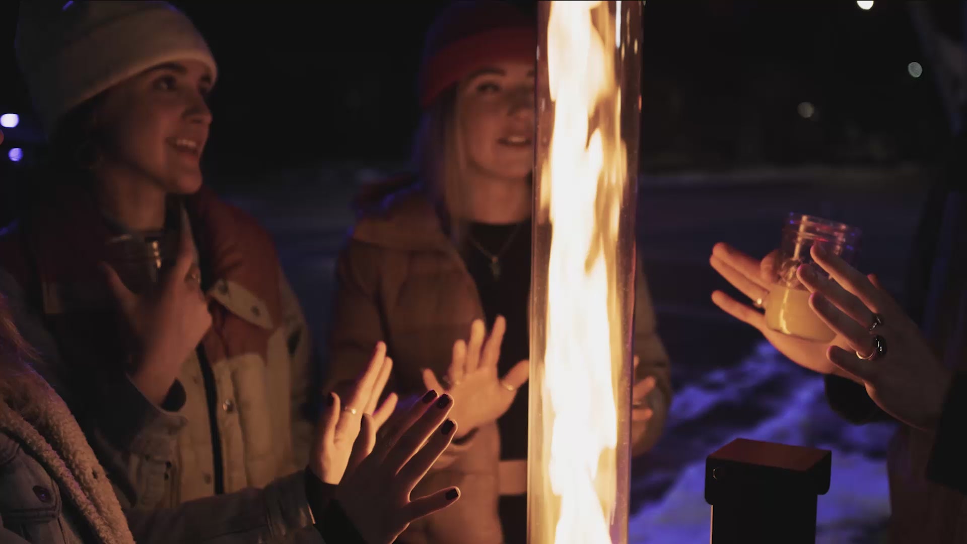 People gathering around Patiofyre patio heater for warmth